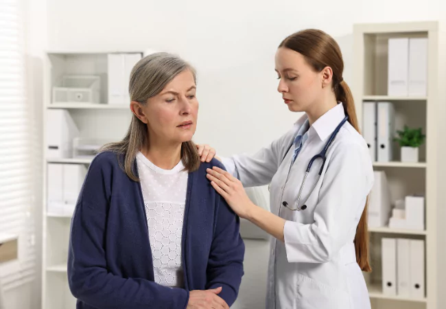 Doctor providing pain relief consultation to mature patient with joint discomfort.
