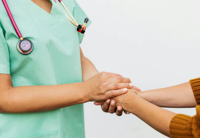 Nurse checking patient’s pulse during a routine wellness exam at Healing Hands Integrative Care.